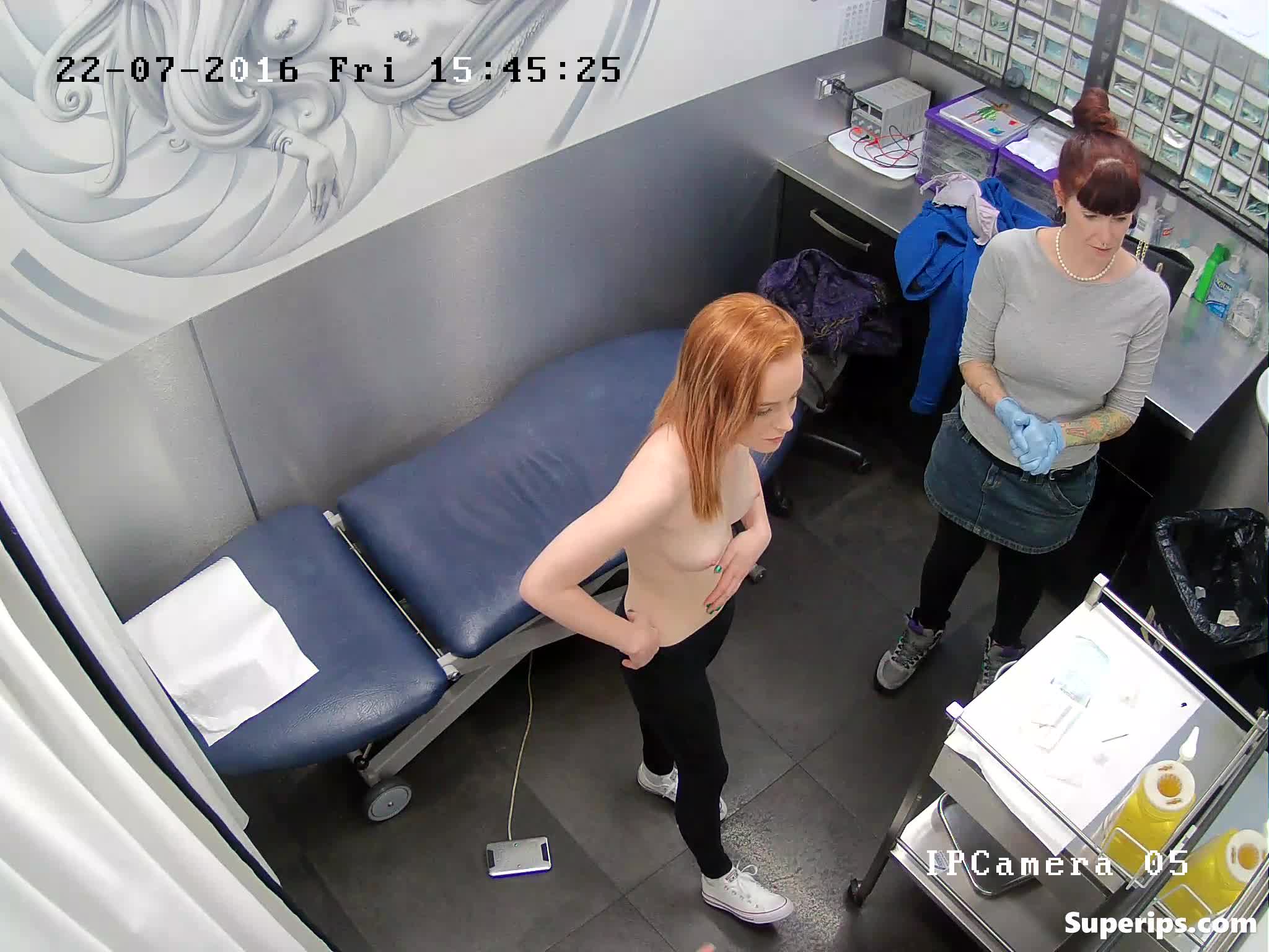 IPCAM – Teenage redhead girl gets her nipples pierced